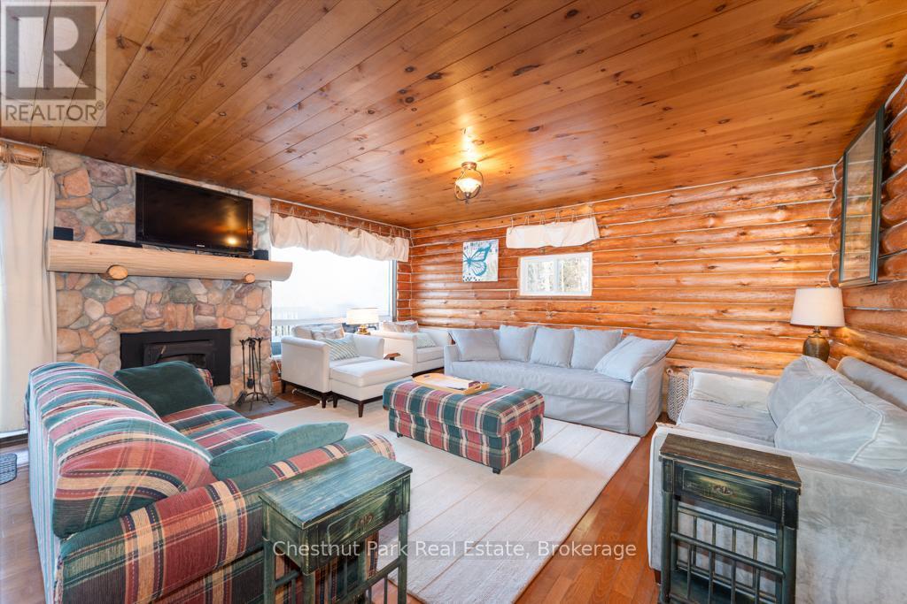 893 Relative Road, Armour, ON - Indoor Photo Showing Living Room With Fireplace