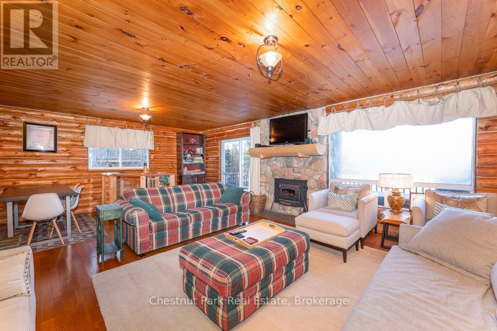893 Relative Road, Armour, ON - Indoor Photo Showing Living Room With Fireplace