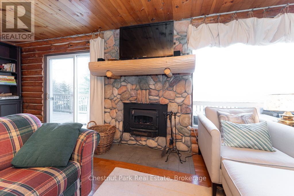 893 Relative Road, Armour, ON - Indoor Photo Showing Living Room With Fireplace