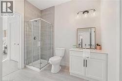 Bathroom with vanity, a stall shower, and light tile patterned floors -