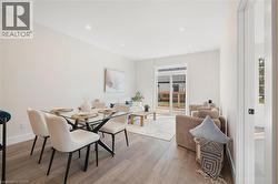 Dining room with recessed lighting and light wood-style flooring -