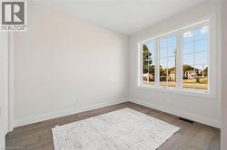 Empty room with baseboards and wood finished floors -