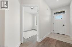 Foyer featuring light wood-type flooring and baseboards -