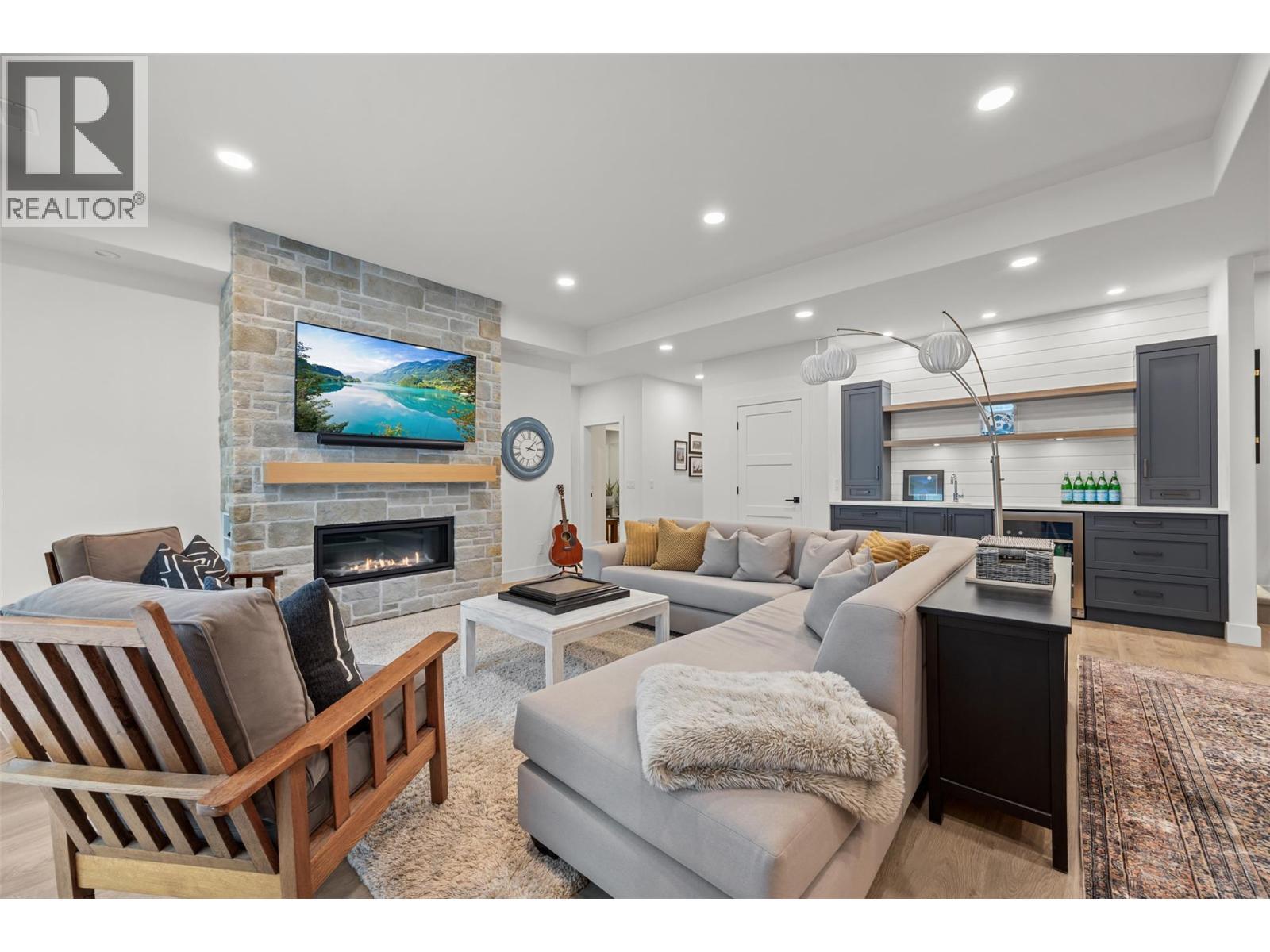 Basement living - 114 Red Sky Court, Kelowna, BC - Indoor Photo Showing Living Room With Fireplace
