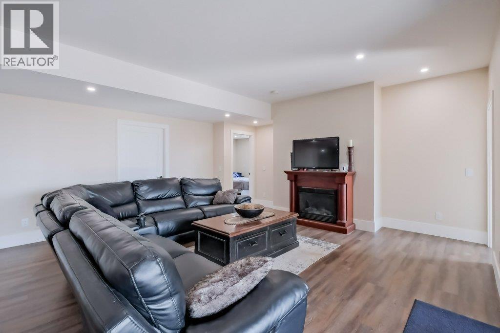 7839 Falcon Ridge Crescent, Kelowna, BC - Indoor Photo Showing Living Room With Fireplace