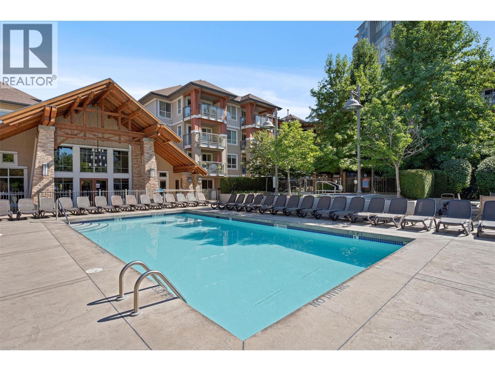 Large pool deck - 1075 Sunset Drive Unit# 1404, Kelowna, BC - Outdoor With In Ground Pool