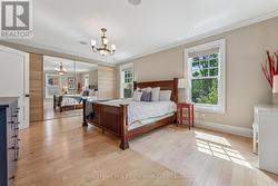 Bright Primary Bedroom Offering Hardwood Flooring -