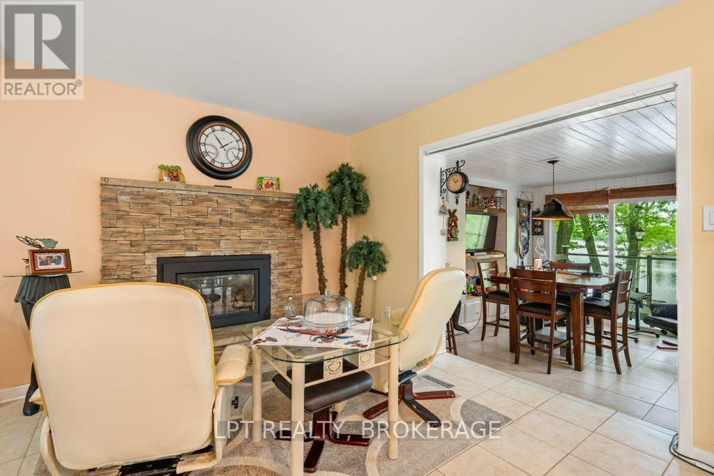 31 Acorn Lane, Frontenac (Frontenac South), ON - Indoor Photo Showing Dining Room With Fireplace
