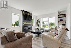 Livingroom electric fireplace flanked by 2 windows -
