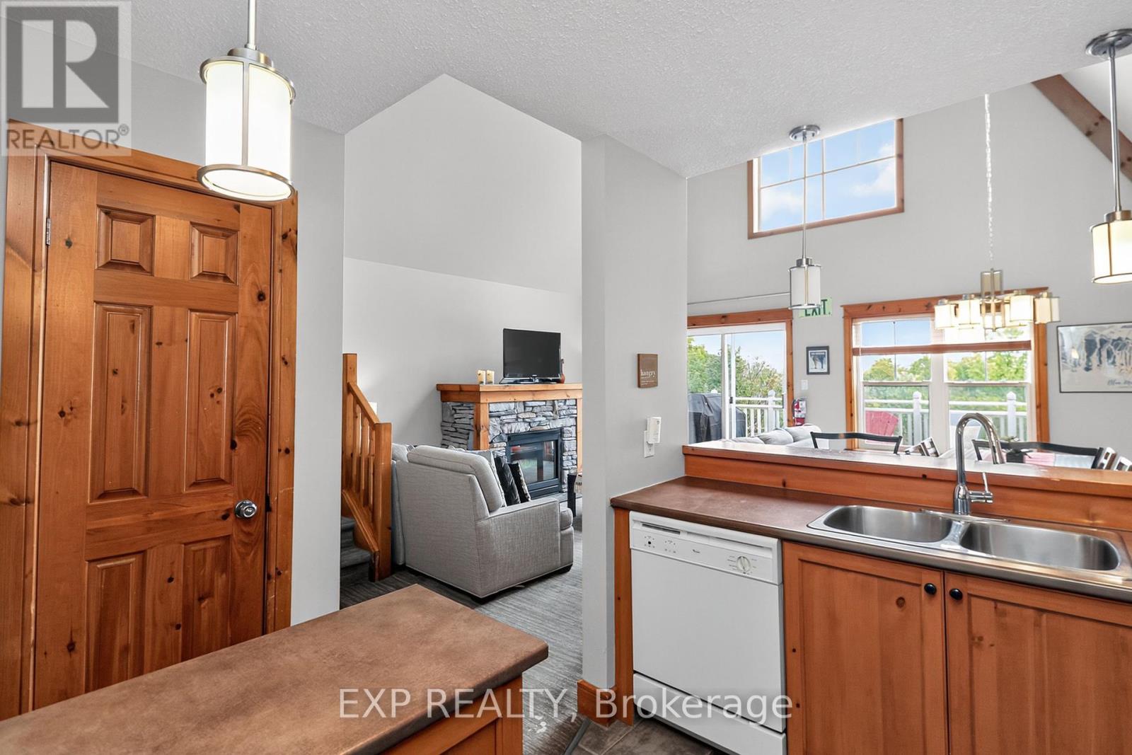 222 - 170 Snowbridge Way, Blue Mountains, ON - Indoor Photo Showing Kitchen With Fireplace With Double Sink