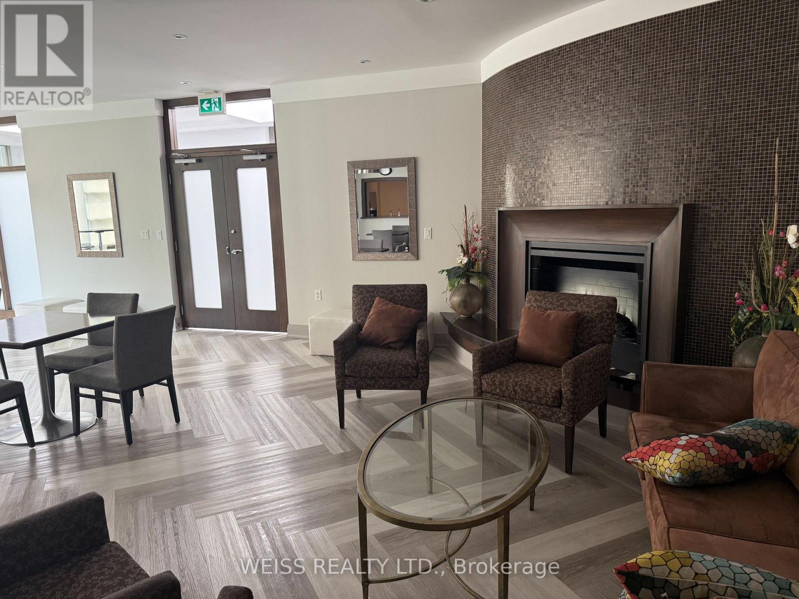 707 - 3830 Bathurst Street W, Toronto, ON - Indoor Photo Showing Living Room With Fireplace