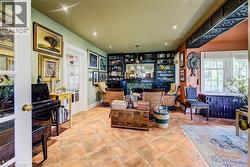Sitting room featuring tile patterned floors, recessed lighting, and a bar -