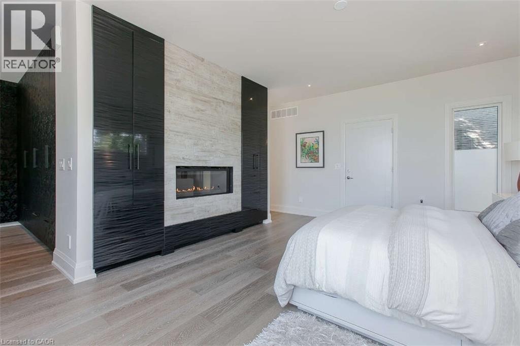 975 Beach Boulevard, Hamilton, ON - Indoor Photo Showing Bedroom With Fireplace