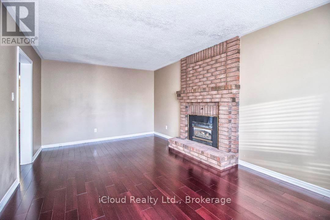 Main Floor Family Room with Hardwood Floors - 2667 Wynten Way, Oakville, ON - Indoor With Fireplace