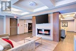 303 - 150 Main Street W, Hamilton, ON - Indoor Photo Showing Living Room With Fireplace