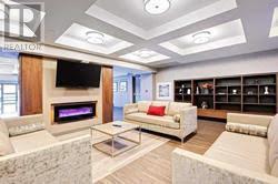 303 - 150 Main Street W, Hamilton, ON - Indoor Photo Showing Living Room With Fireplace