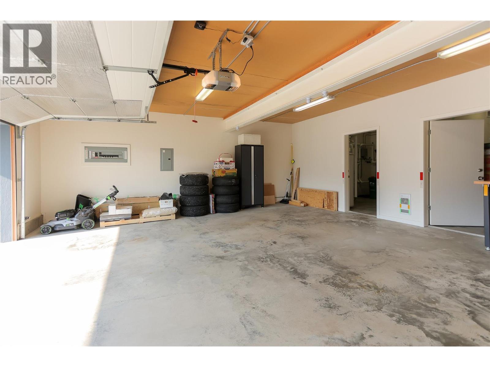 garage door open - 1006 Silvertip Road, Rossland, BC - Indoor Photo Showing Garage