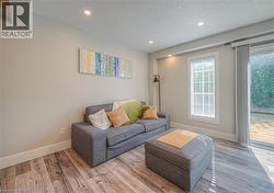 Living area featuring a textured ceiling, recessed lighting, and wood finished floors -