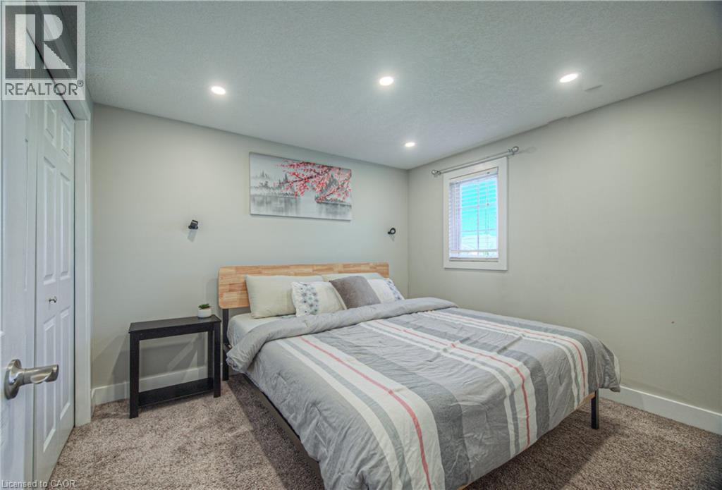 Bedroom featuring carpet floors, recessed lighting, a closet, and a textured ceiling - 220 Sienna Crescent, Kitchener, ON - Indoor Photo Showing Bedroom