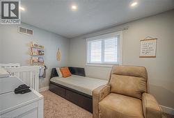 Bedroom featuring light colored carpet, recessed lighting, and a textured ceiling -