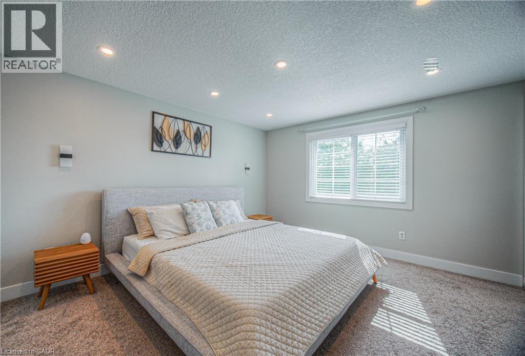 Bedroom with carpet, a textured ceiling, and recessed lighting - 220 Sienna Crescent, Kitchener, ON - Indoor Photo Showing Bedroom