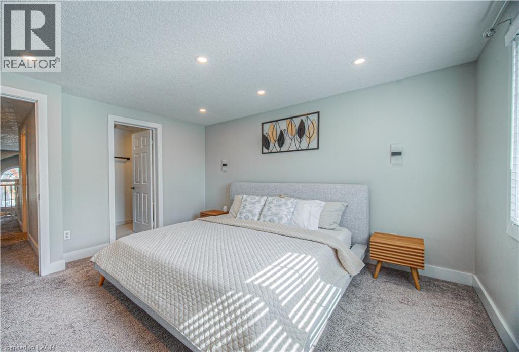 Bedroom with light carpet, a textured ceiling, and recessed lighting - 220 Sienna Crescent, Kitchener, ON - Indoor Photo Showing Bedroom