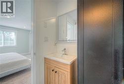 Bathroom with vanity, a textured ceiling, ensuite bath, and recessed lighting -