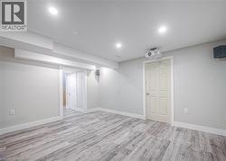 Finished basement featuring light wood-type flooring and recessed lighting -
