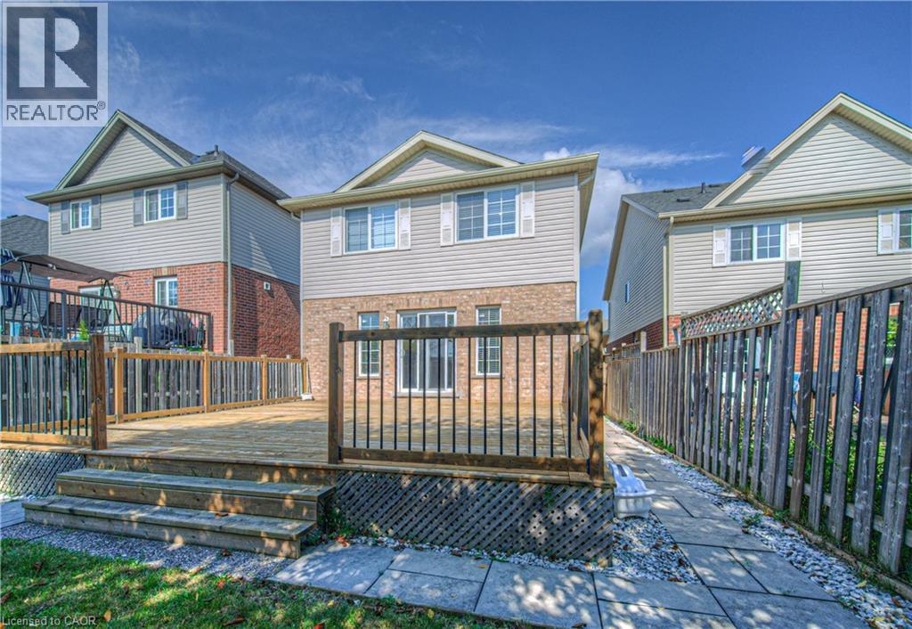 Rear view of property featuring a deck, a fenced backyard, and brick siding - 220 Sienna Crescent, Kitchener, ON - Outdoor With Deck Patio Veranda