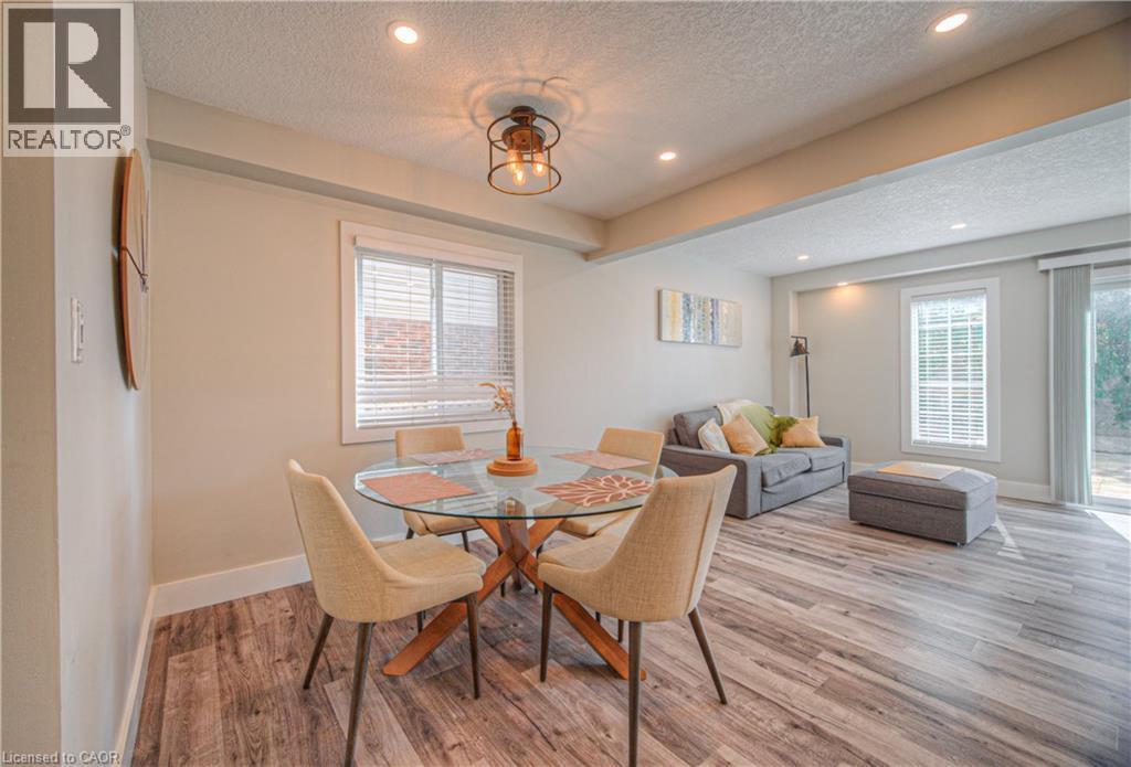 Dining room with a textured ceiling, plenty of natural light, light wood-style floors, and recessed lighting - 220 Sienna Crescent, Kitchener, ON - Indoor Photo Showing Dining Room