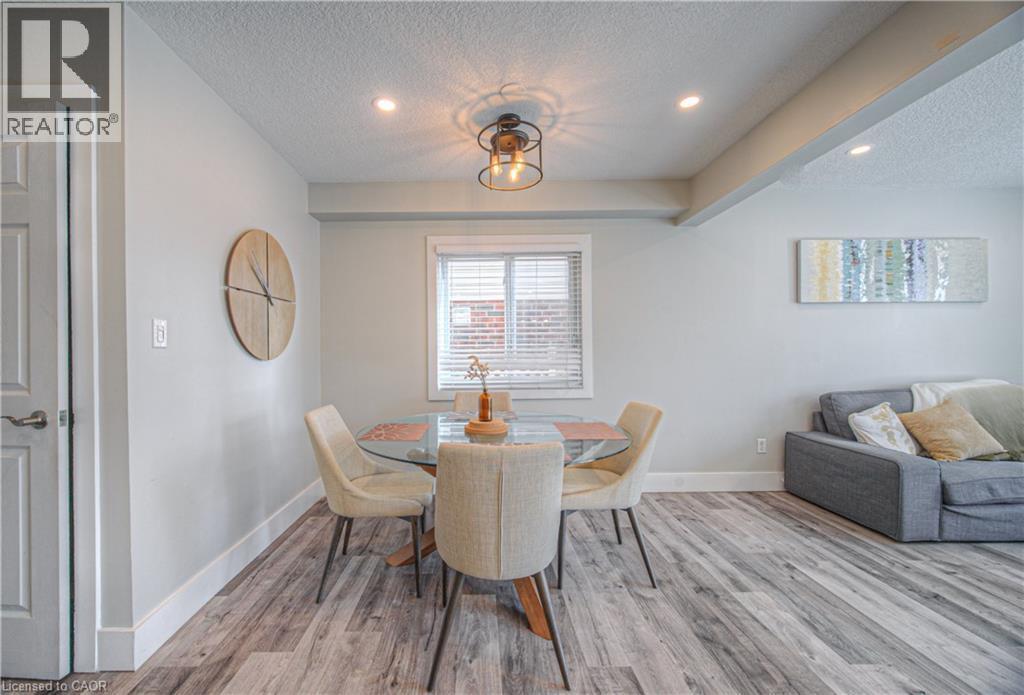 Dining room featuring a textured ceiling, wood finished floors, and recessed lighting - 220 Sienna Crescent, Kitchener, ON - Indoor Photo Showing Dining Room