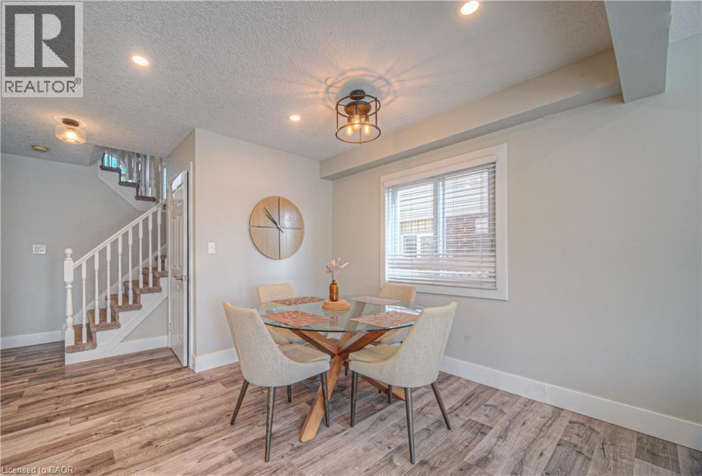 Dining room featuring a textured ceiling, light wood finished floors, stairway, and recessed lighting - 220 Sienna Crescent, Kitchener, ON - Indoor Photo Showing Dining Room