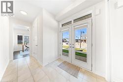 Entryway featuring french doors and tile patterned flooring -