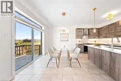Dining room with light tile patterned flooring and a chandelier -