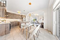 Dining room featuring light tile patterned flooring and a chandelier -