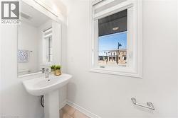 Bathroom featuring plenty of natural light and light tile patterned floors -