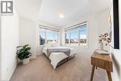 Bedroom featuring light carpet and baseboards -