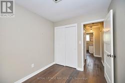 3rd bedroom looking down hall to 4 pc bath -