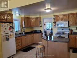 Kitchen with a view into the back foyer area. -