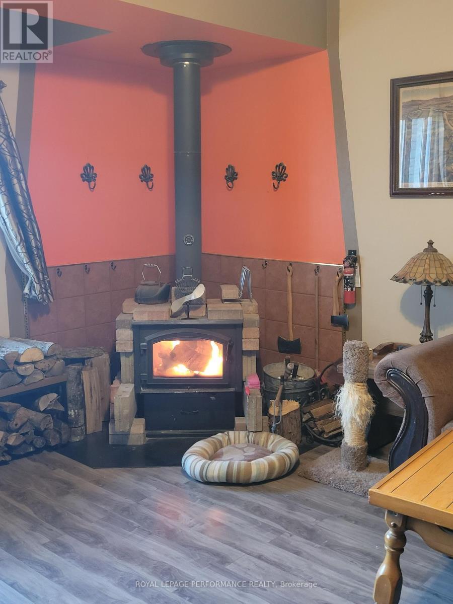 New wood stove with a lovely fire. - 975 Queen Street, Champlain, ON - Indoor With Fireplace