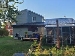 View of the back of the home with a new metal roof -