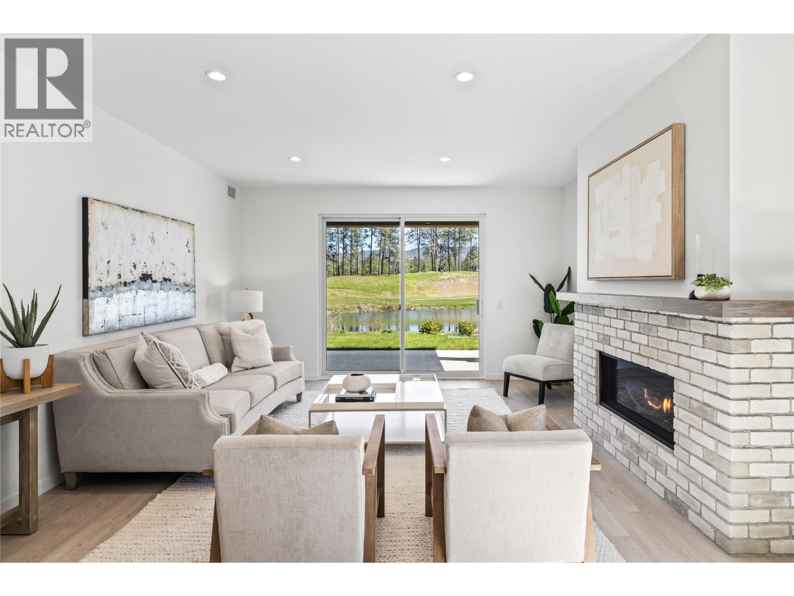 Living Room - Photo of a similar home in the community. - 1979 Country Club Drive Unit# 6, Kelowna, BC - Indoor Photo Showing Living Room With Fireplace