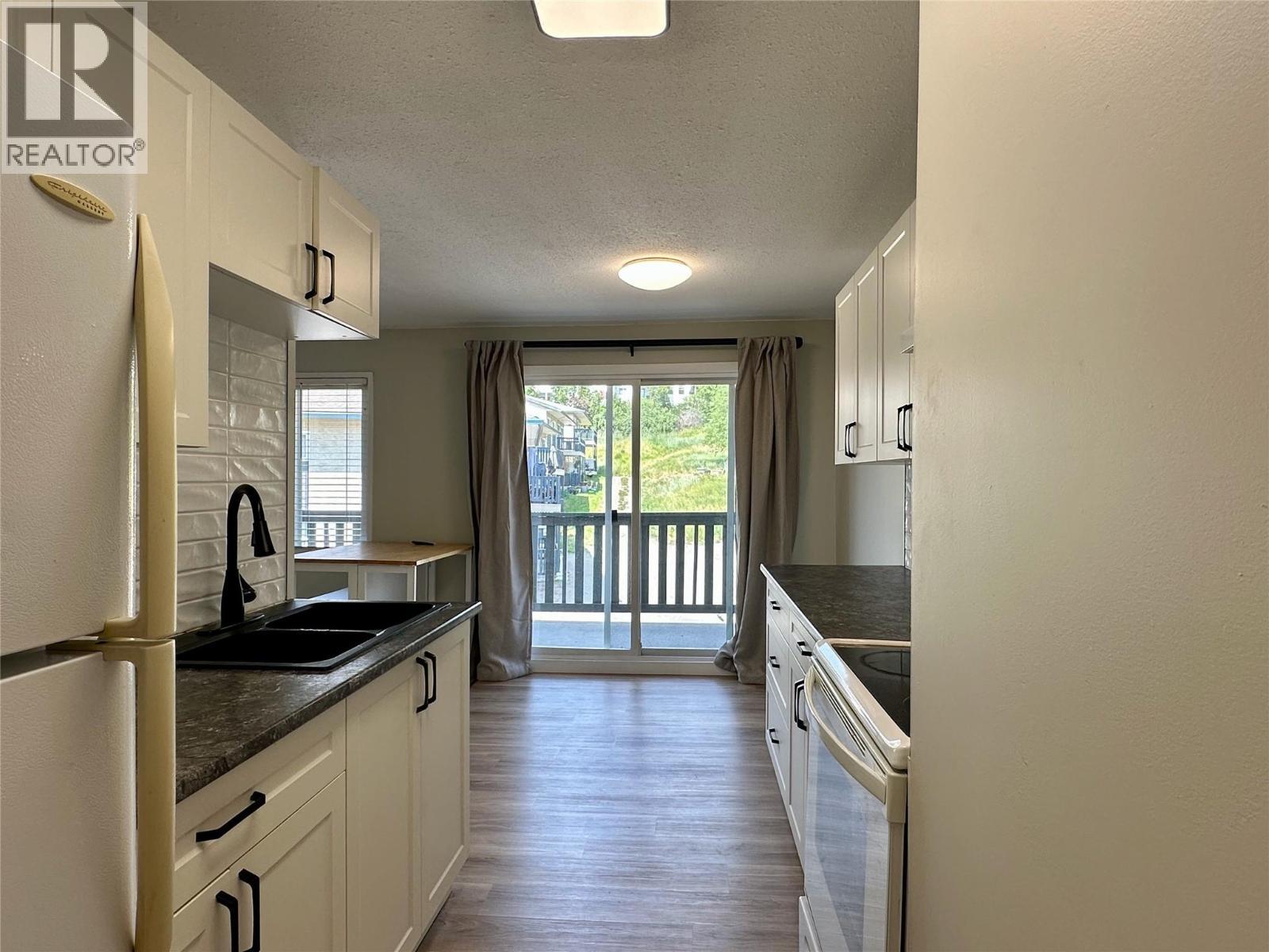 Updated Galley Kitchen - 3505 38 Street Unit# 215, Vernon, BC - Indoor Photo Showing Kitchen With Double Sink