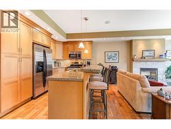 Kitchen with granite counters, eating bar, stainless steel appliances (gas stove) -