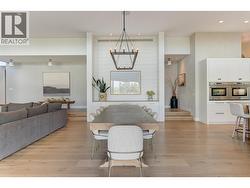 Dining area with seating for 8 is perfectly balanced by an overhead chandelier -