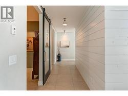 Shiplap wall detailing along the hallway plus custom lighting. -