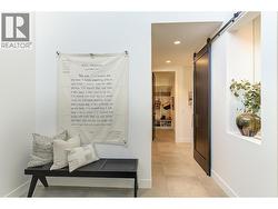 Beautiful front entry with hallway leading back to guest bedroom, laundry & mudroom -