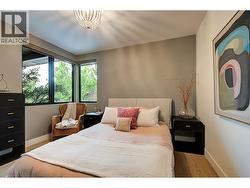 Main floor guest bedroom is a calm oasis with corner window, full size closet and wide plank oak hardwood floor just steps from the 3 piece bathroom down the hall. -