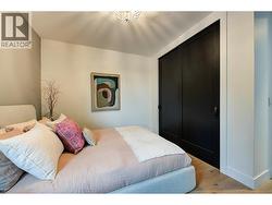 Closet has built in shelving and automatic lighting -