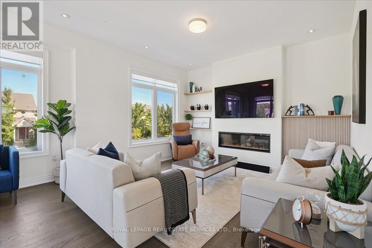 Family room with electric fireplace & shelving - 2180 Postmaster Drive, Oakville, ON - Indoor Photo Showing Living Room With Fireplace